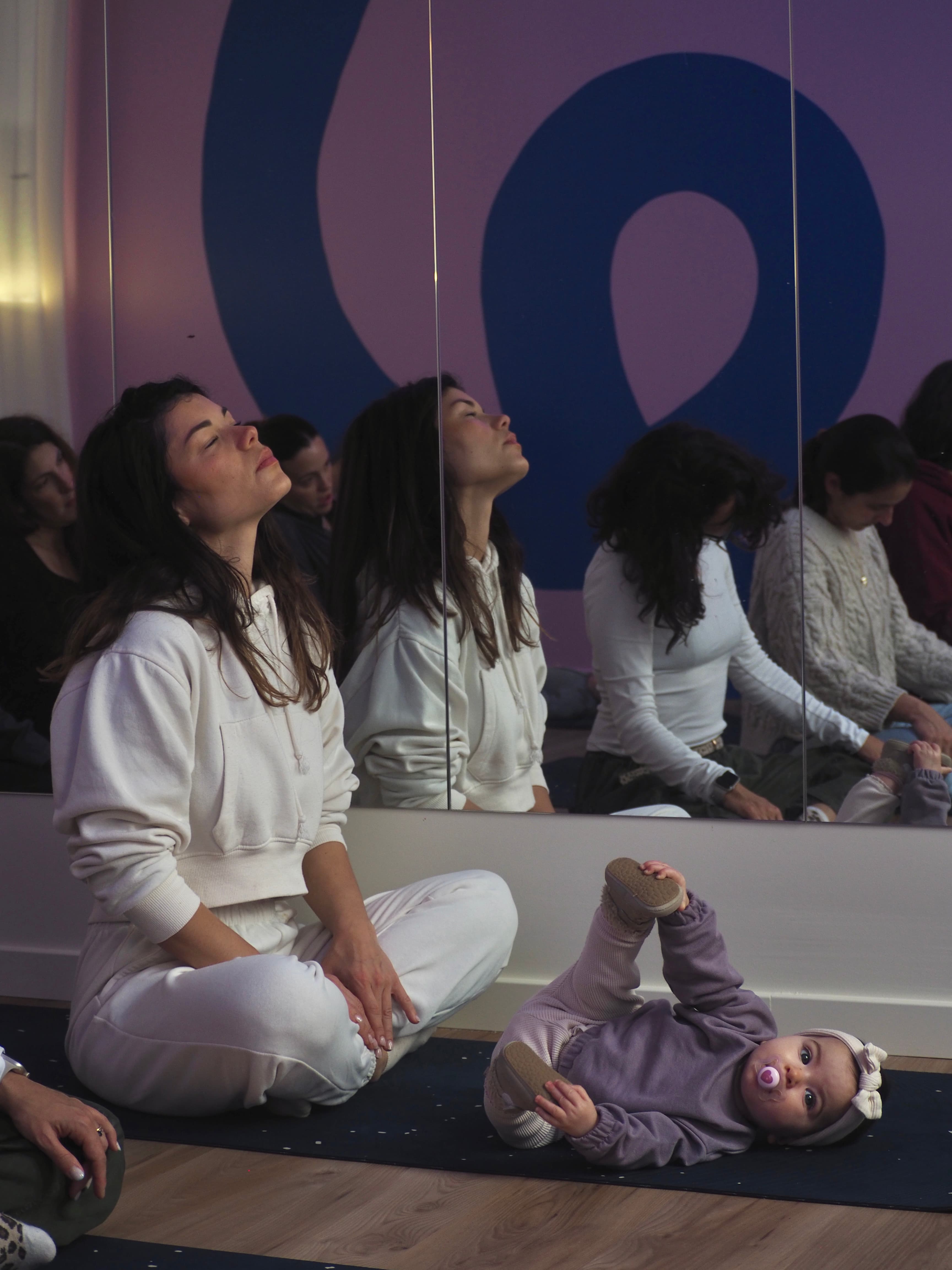 Parent stretching on a mat during a calm movement session at Circle