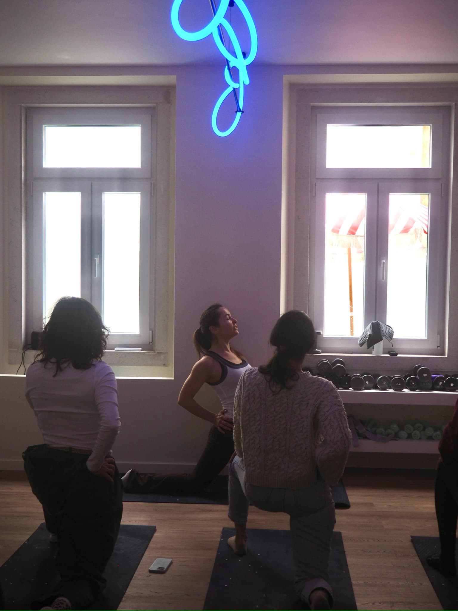 Parent practicing yoga on a mat during a Circle movement ritual
